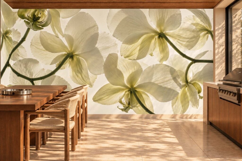 Wallpaper mural features oversized pale orchid flowers in soft, muted tones. The delicate petals and gentle color gradients stand out against a subtle background, making orchid blooms the focal point of the wall decor.