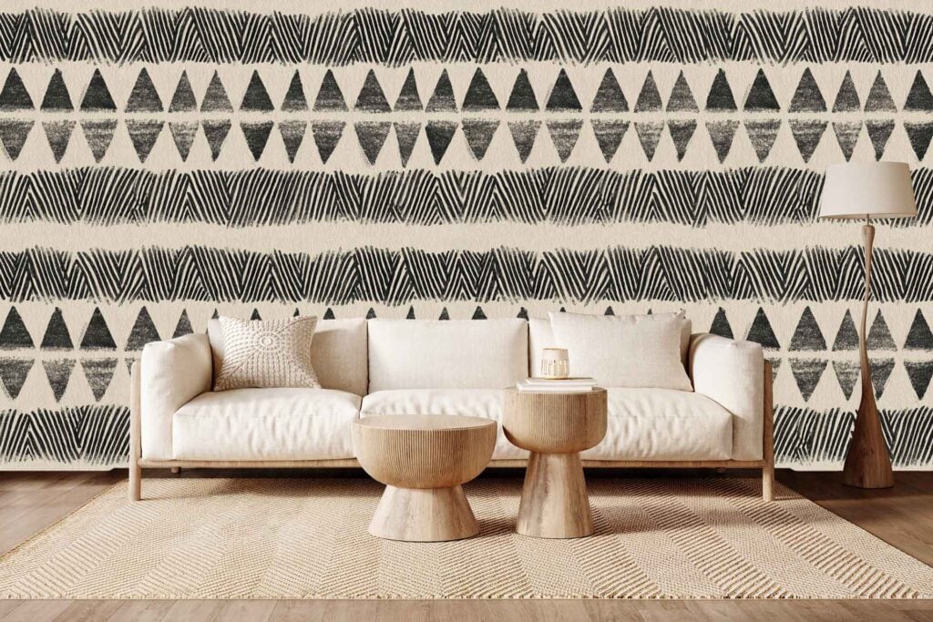 Wallpaper with a striking geometric design featuring black and beige triangles and zigzags; bold patterns and neutral colors dominate the wall.
