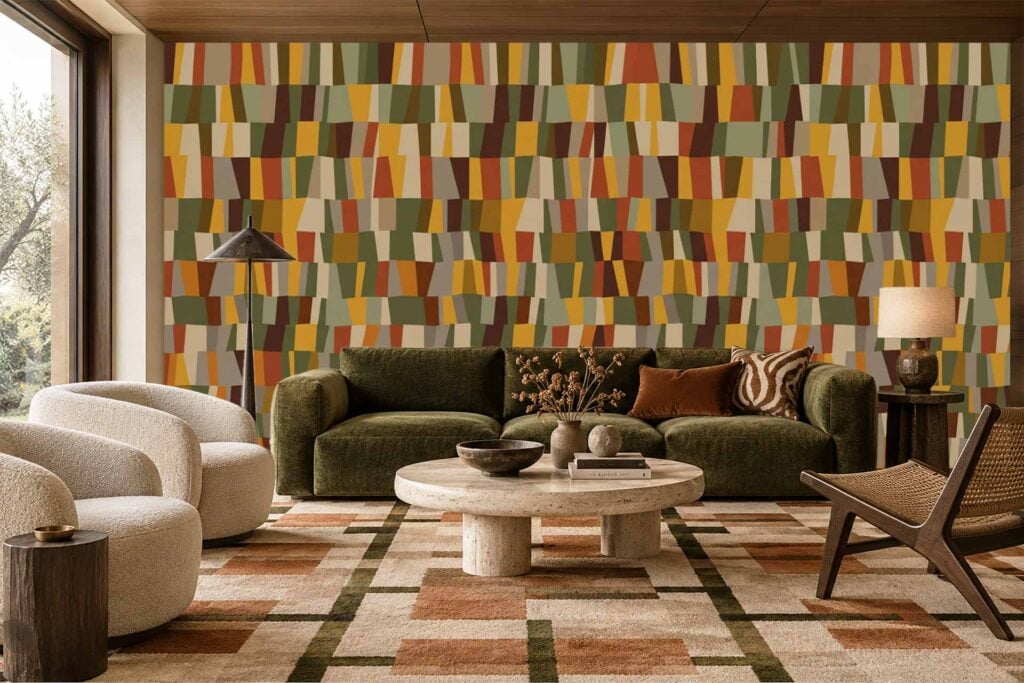 Geometric multicolored accent wallpaper featuring bold shapes in shades of blue, green, mustard yellow, and terracotta. The pattern adds vibrancy to the living room décor.