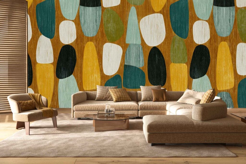 Colorful abstract wall mural with bold yellow, teal, green, brown, and white shapes as the main focus. The wallpaper’s large geometric forms and vivid colors create a striking modern backdrop.