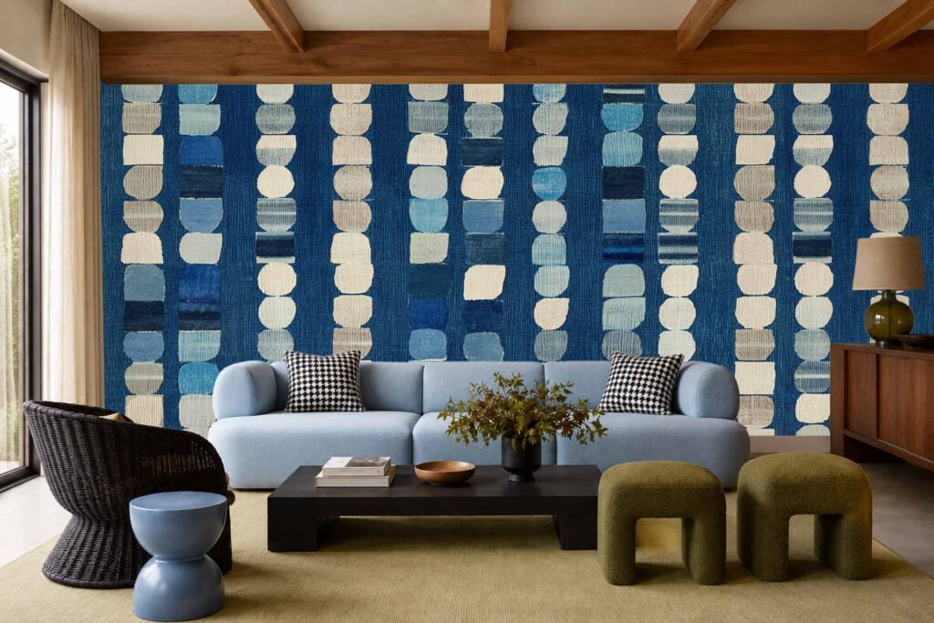 Geometric wallpaper with bold blue and cream patterns covers the back wall, showcasing striking shapes and contrasting colors.