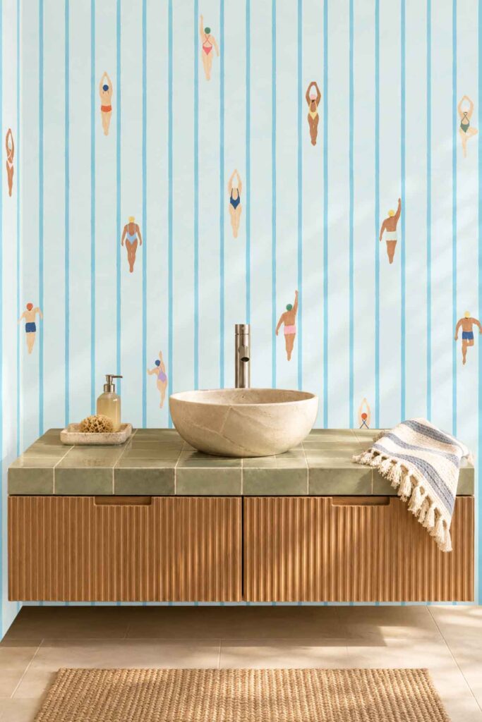 The wallpaper is light blue with vertical stripes and features illustrated swimmers in various poses, creating a playful and aquatic-themed backdrop.