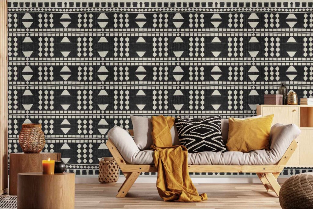 Bold black-and-white geometric patterned wallpaper with striking shapes and contrasting colors creates a dramatic backdrop in the living room.