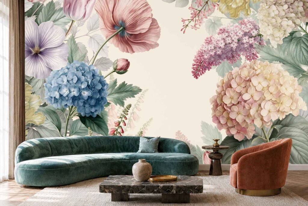 Wallpaper featuring large-scale, soft-colored floral illustrations of blue and pink hydrangeas, purple lilacs, and pink poppies on a cream background.