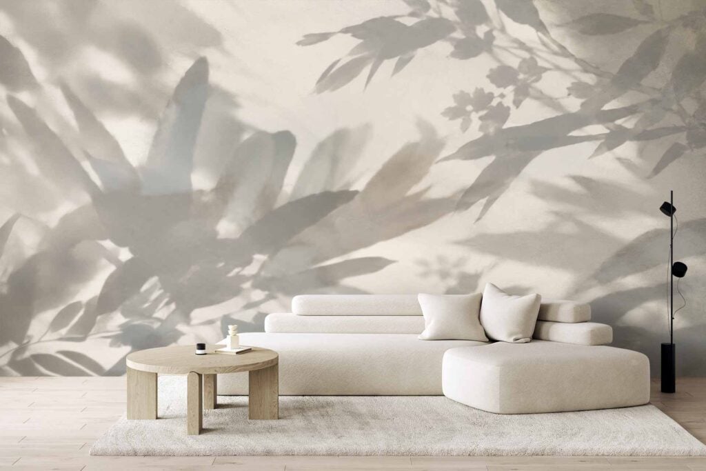 Large mural wallpaper with abstract leaf shadows in neutral tones, featuring soft shapes and shades of beige, cream, and taupe for a calm, minimalist look. Subtle botanical elements create a serene atmosphere on the wall.
