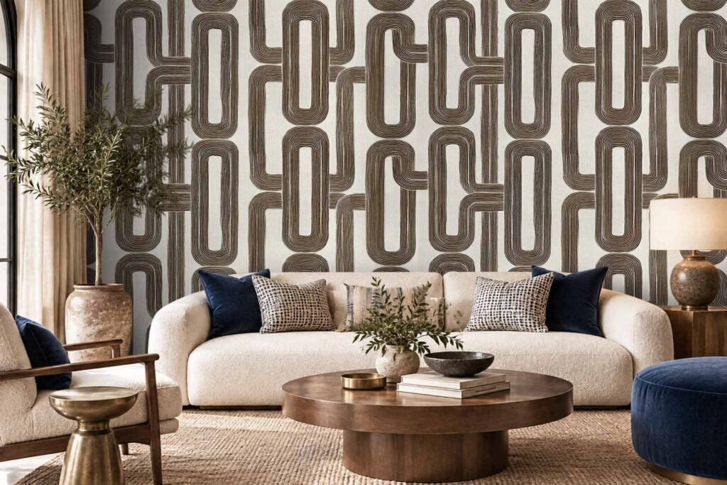 A modern living room features a bold geometric wallpaper with striking angular shapes and contrasting colors, designed in shades of deep blue, cream, and gold that create a standout visual effect.